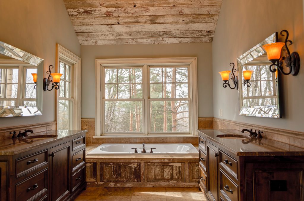 Rustic bathroom with wood cabinets and bath