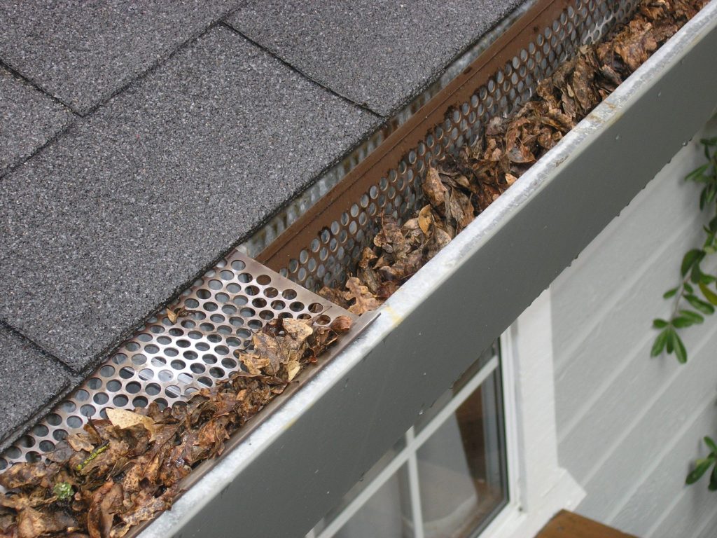 Photo of guttering filled with leaves