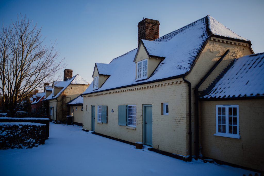 Photograph of cottages with snow on ground
