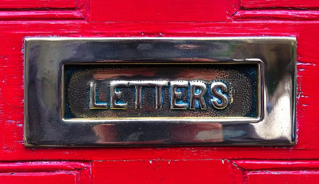 Close up photograph of a letterbox with the word "Letters" embossed