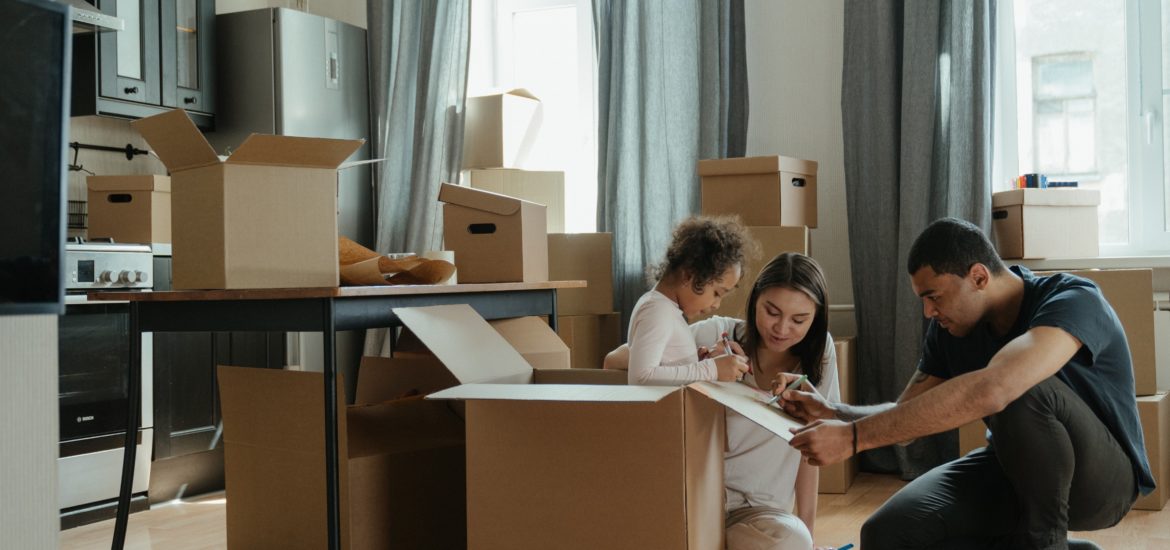 Photo of a family in their new home, surrounded by boxes