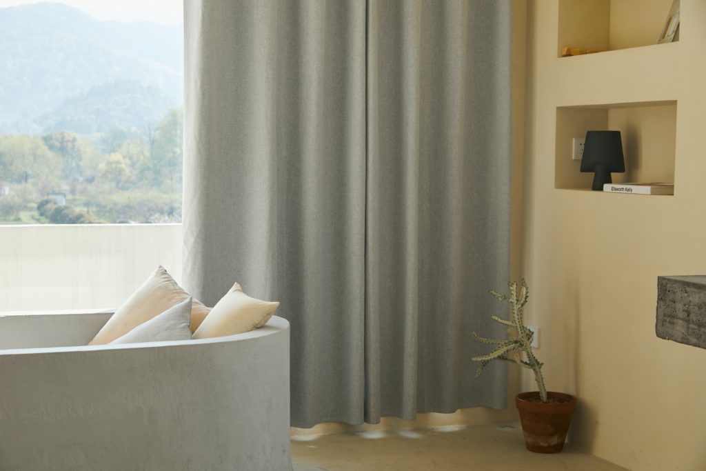 Photograph of grey curtains in a living room