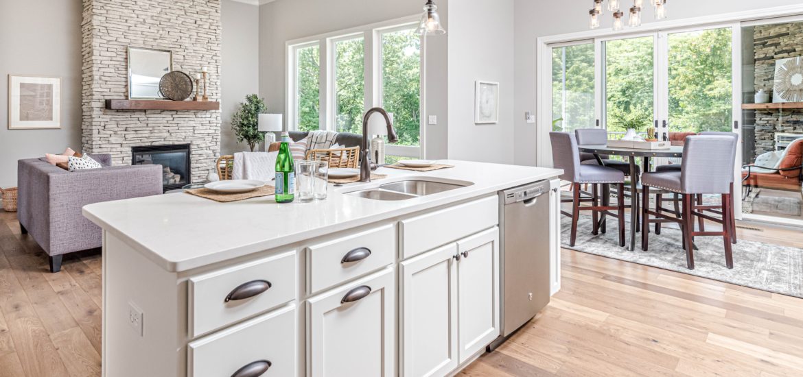 Photograph of open plan kitchen/living room/dining room taken from the kitchen area
