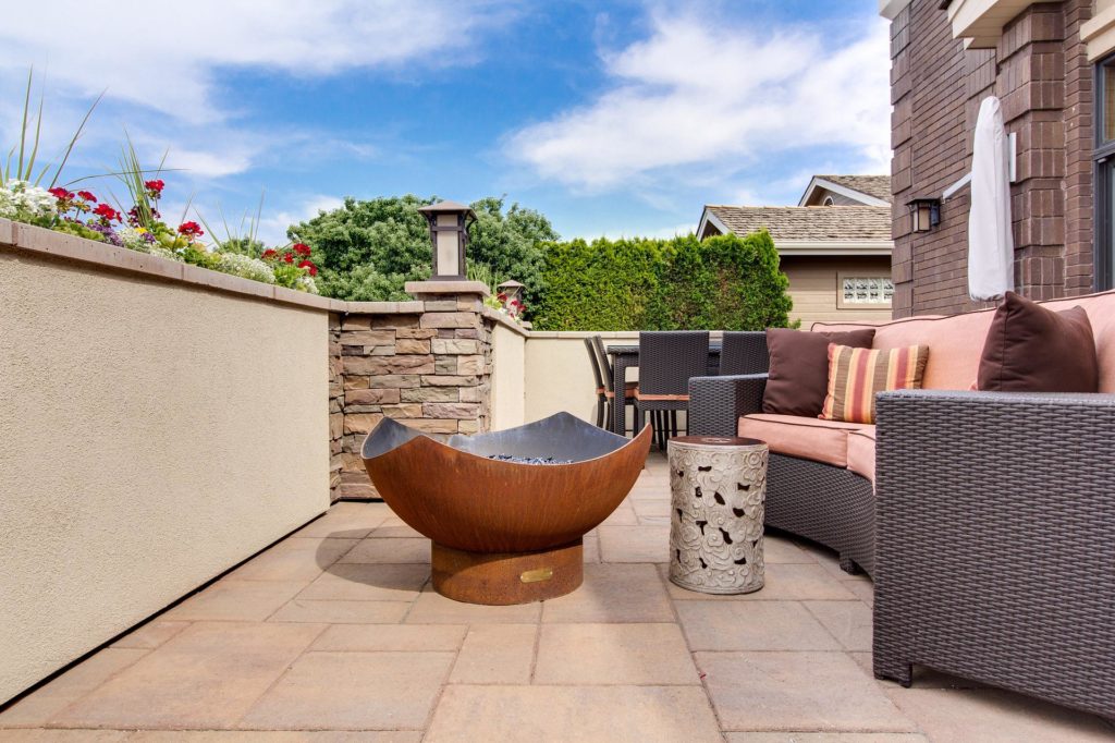 Photo of a patio with seating, table and firepit