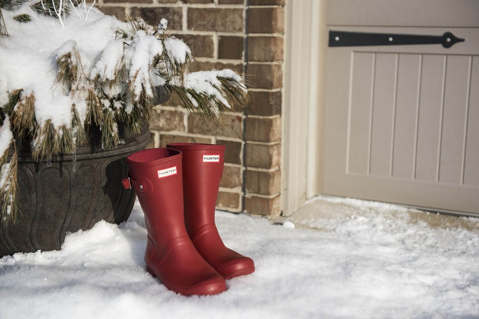 Wellington boots outside a door in the snow