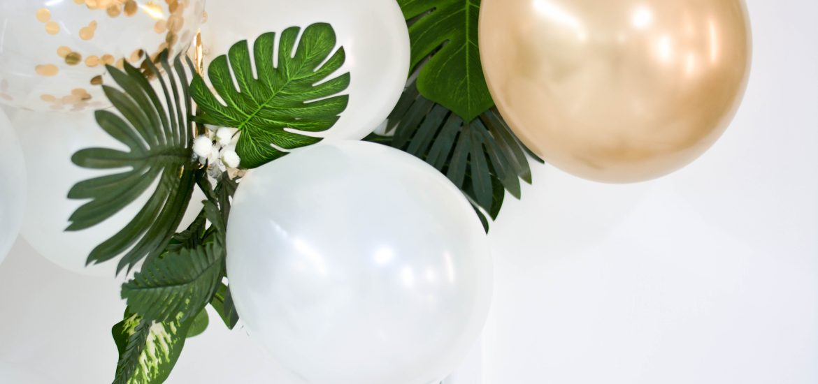 white and gold balloons with leafy houseplants