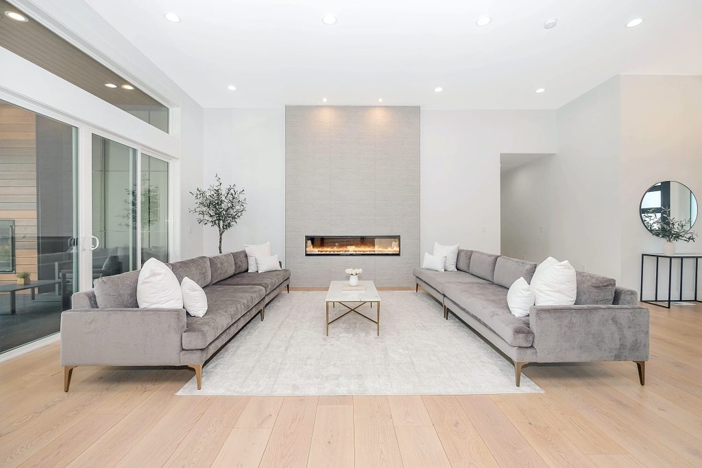 Quiet luxury living room with grey velvet sofas and sliding glass doors