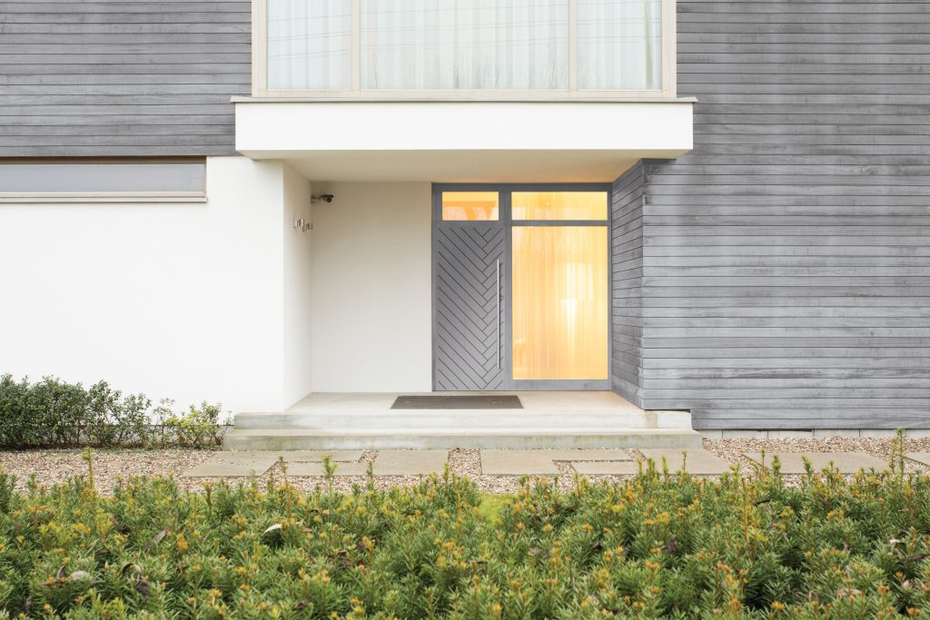 Grey composite front door for a modern home