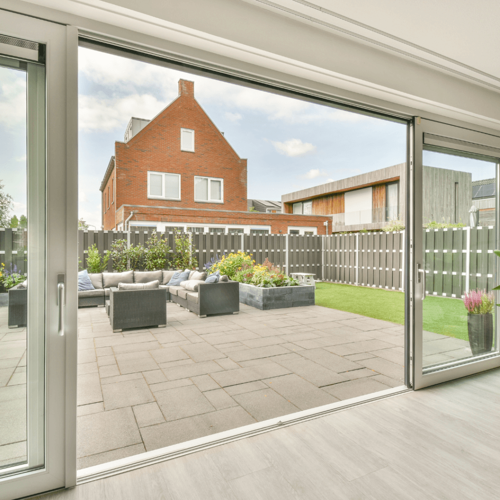 Sliding doors leading out to a paved patio area